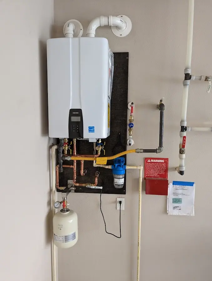 Professional plumber installing copper piping in a Camden home